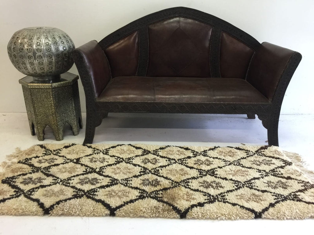 Beni ourain rug & Moroccan carved leather bench